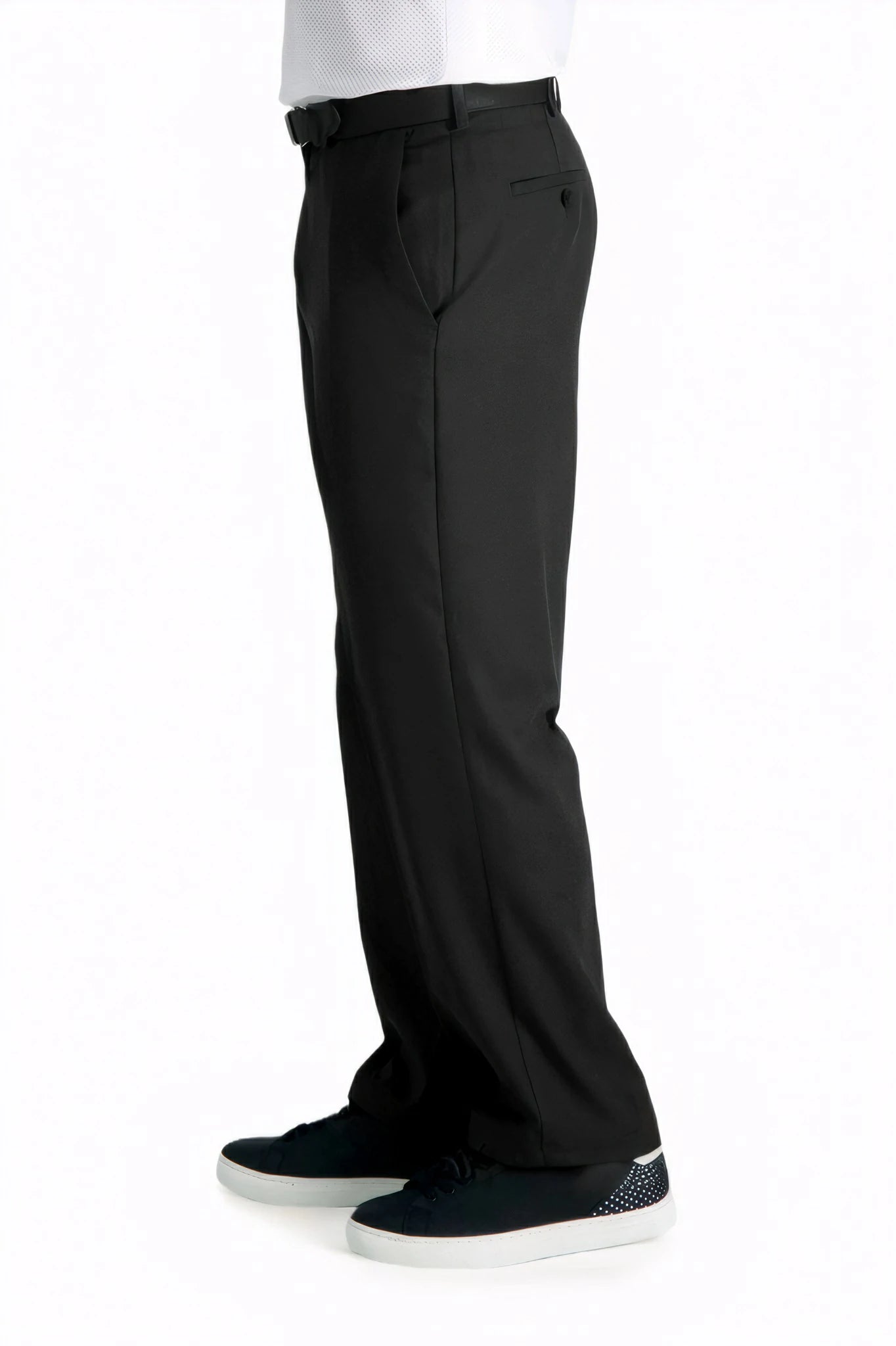 side view of a man wearing solid black dress pants with two side pockets