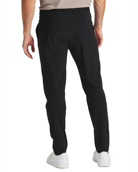 back view of a man wearing solid black golf pants with zippered back pockets