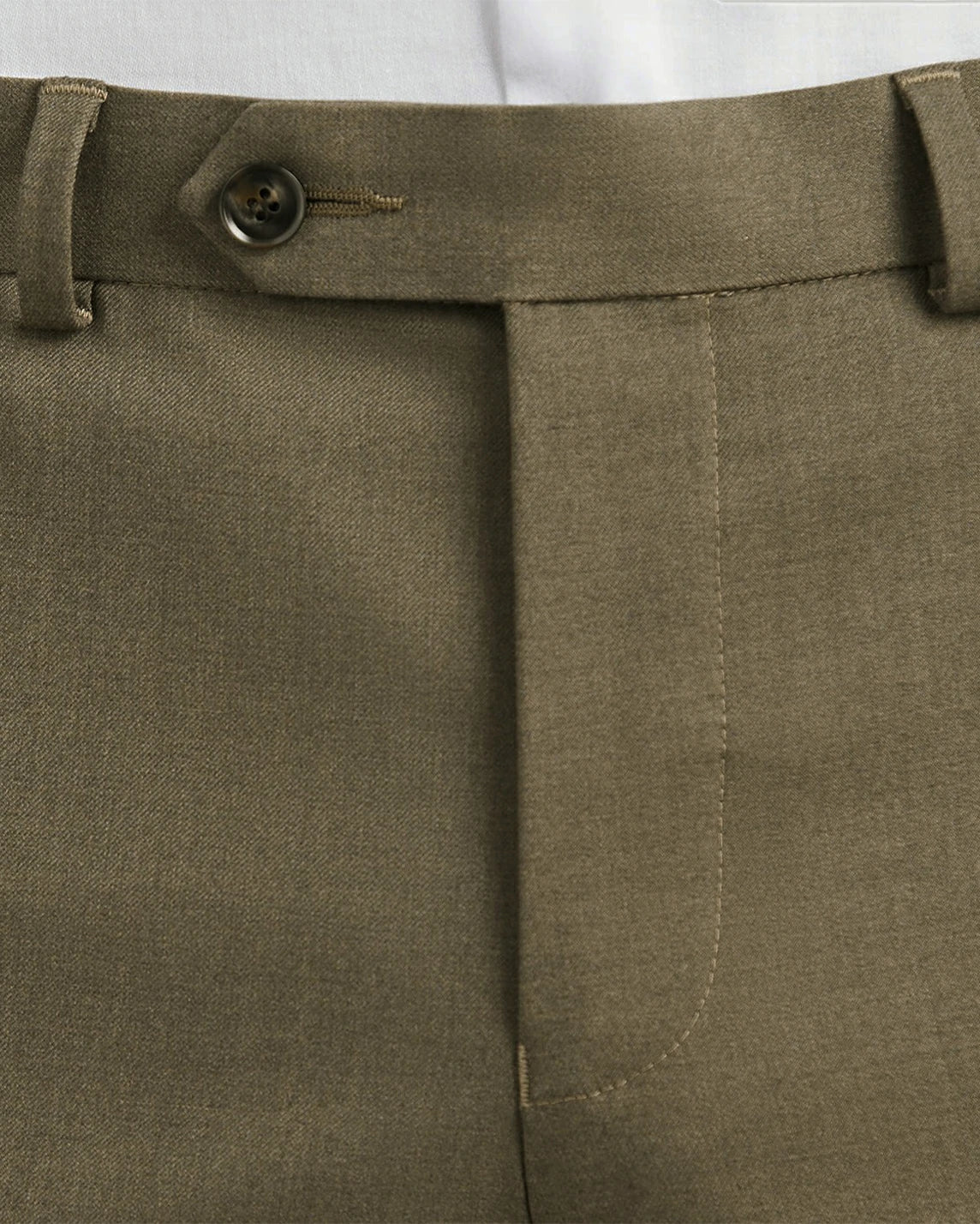 close-up of the button on men's brown dress pants