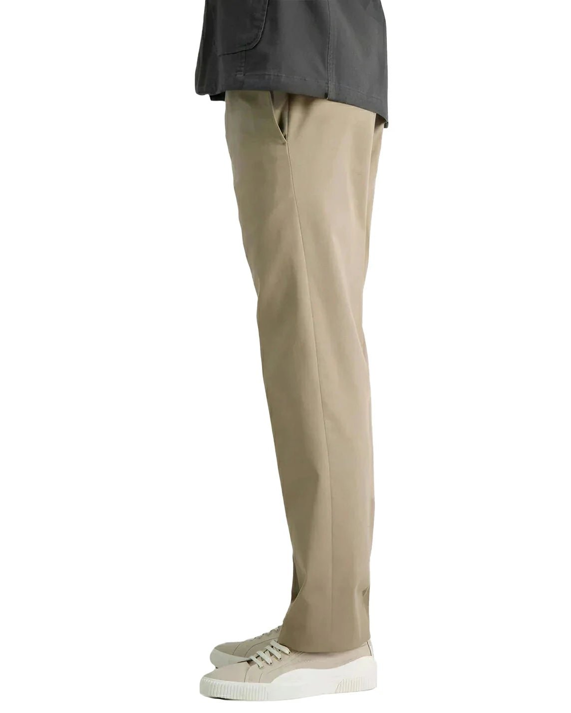 side view of a man wearing solid khaki casual pants with two side pockets