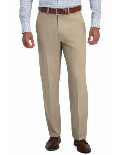 front view of a man wearing solid khaki dress pants with button and zipper closure