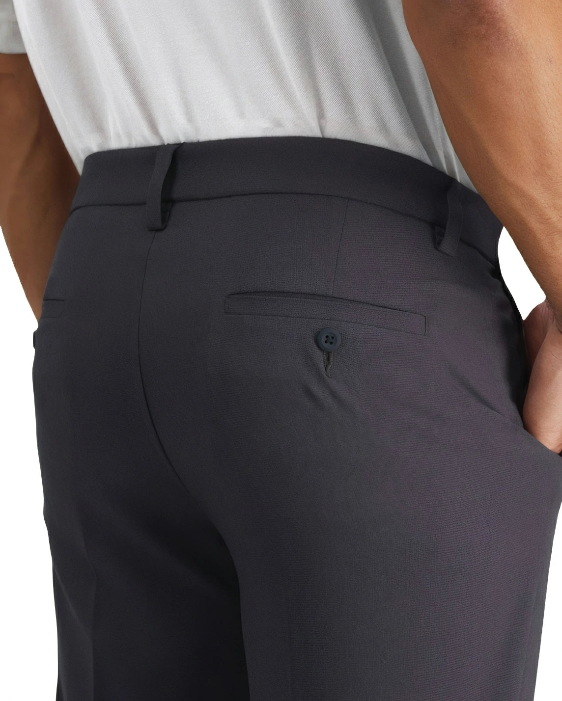 a close-up of the button back pocket of mens grey pants