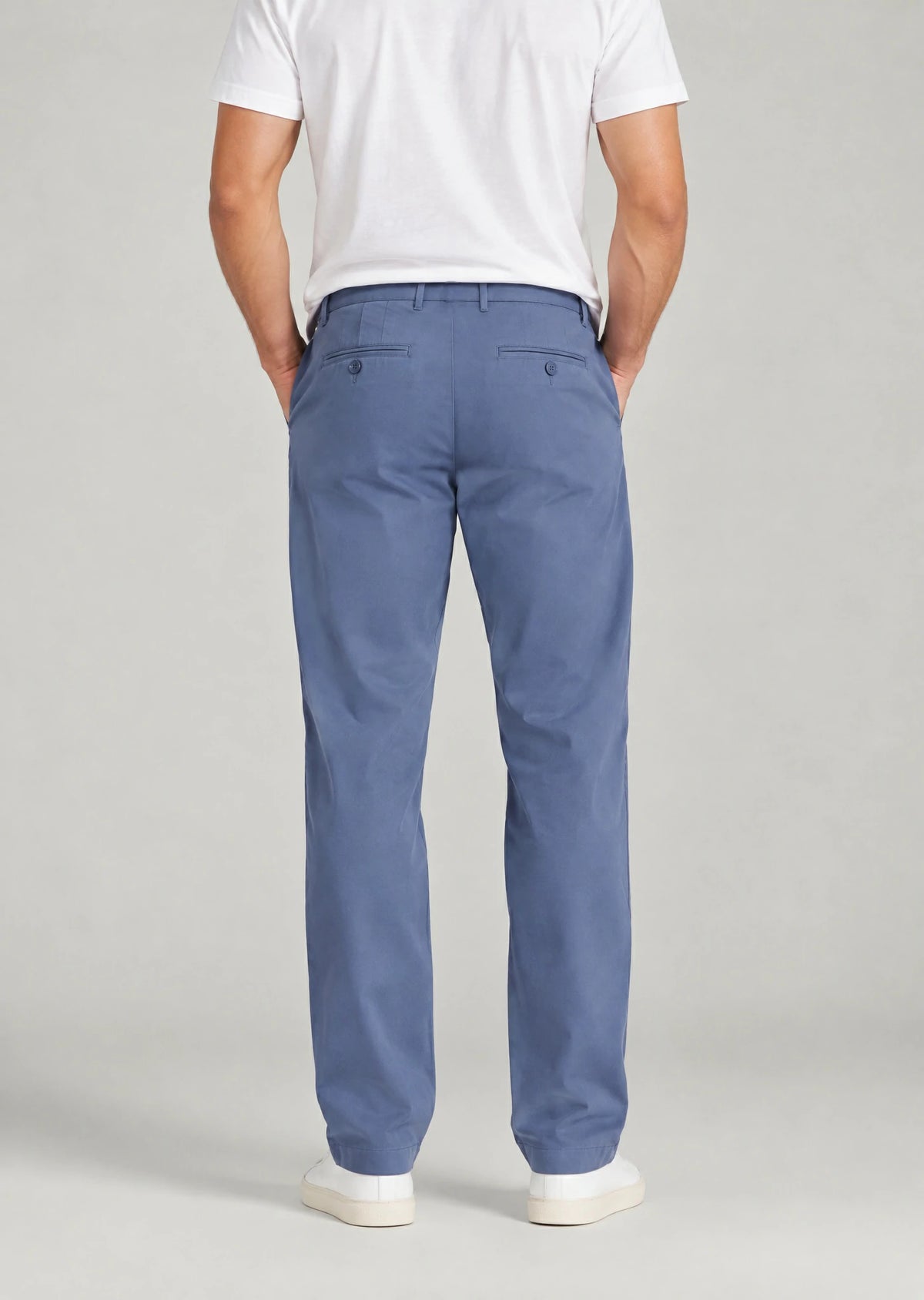 Back view of men's classic fit indigo blue cotton pants with button welt back pockets, non-stretch casual trousers