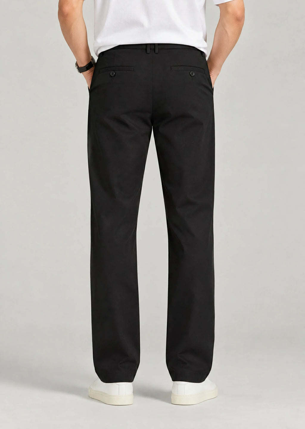 Back view of men's black pants with button welt pockets and expandable waist, loose fit office trousers