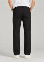 Back view of men's black pants with button welt pockets and expandable waist, loose fit office trousers