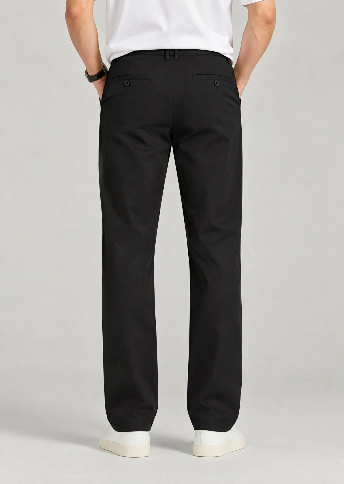 Back view of men's black pants with button welt pockets and expandable waist, loose fit office trousers