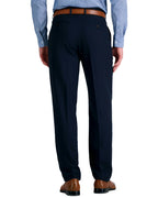 back view of a man wearing solid navy blue dress pants with button back pockets