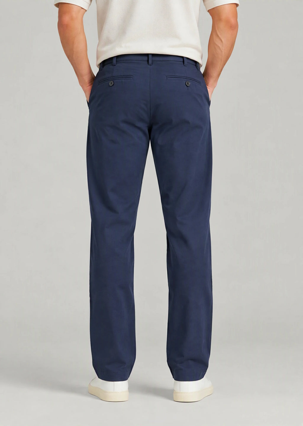 Back view of men's classic fit navy blue cotton pants with button welt back pockets, non-stretch casual trousers