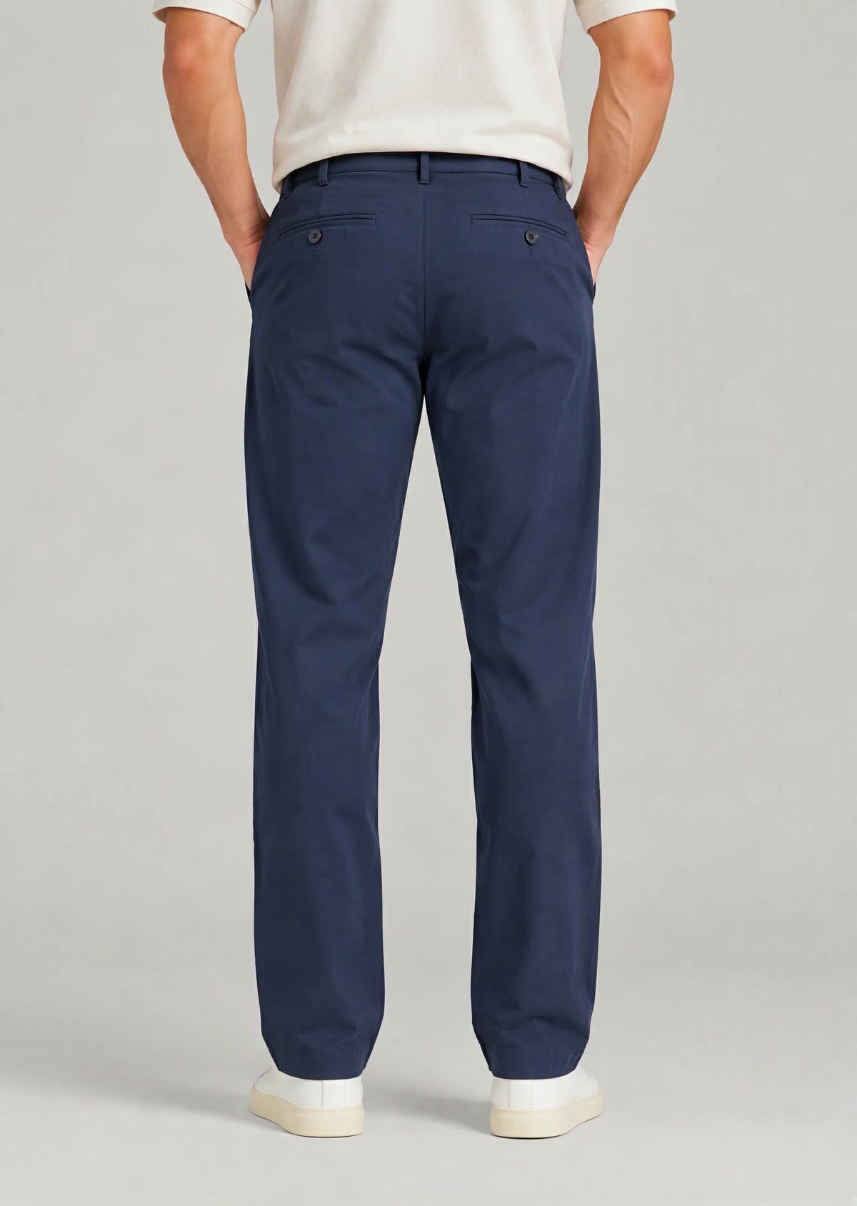 Back view of men's classic fit navy blue cotton pants with button welt back pockets, non-stretch casual trousers