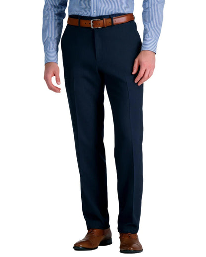 front view of a man wearing solid navy blue dress pants with button and zipper closure