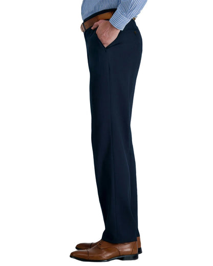 side view of a man wearing solid navy blue dress pants with two side pockets